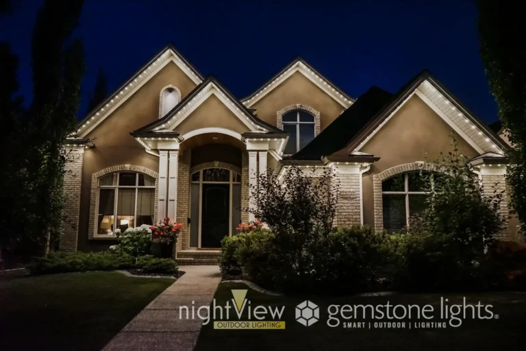 Permanent Christmas lighting installed along the roofline of a home, creating a soft, warm glow across the exterior at night.